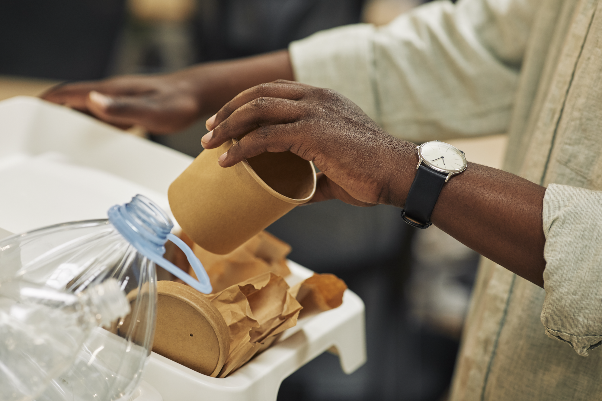 Man Recycling Paper Cup Close Up