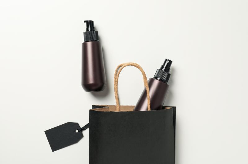 Spray With Minimalist Packaging Coming Out Of A Shopping Bag